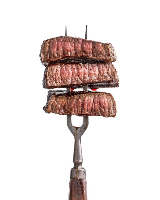 2 prong meat fork with three cuts of beef on it’.